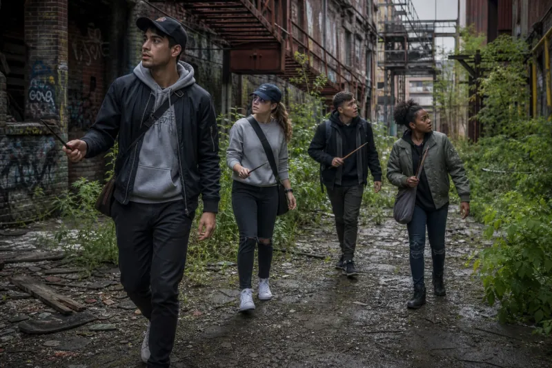 Explorers crossing through a graffitied urban alley